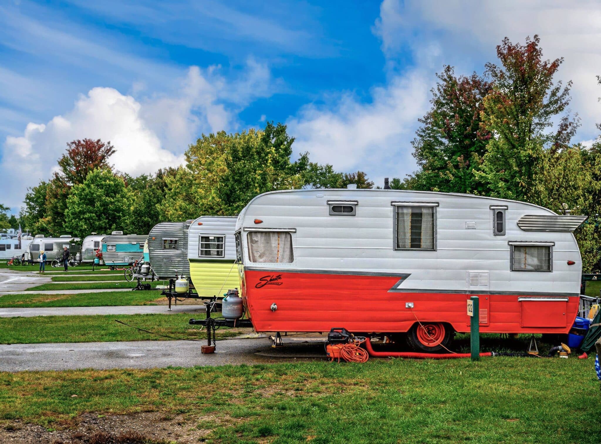 Colorful vintage trailers parked in a scenic campground 1