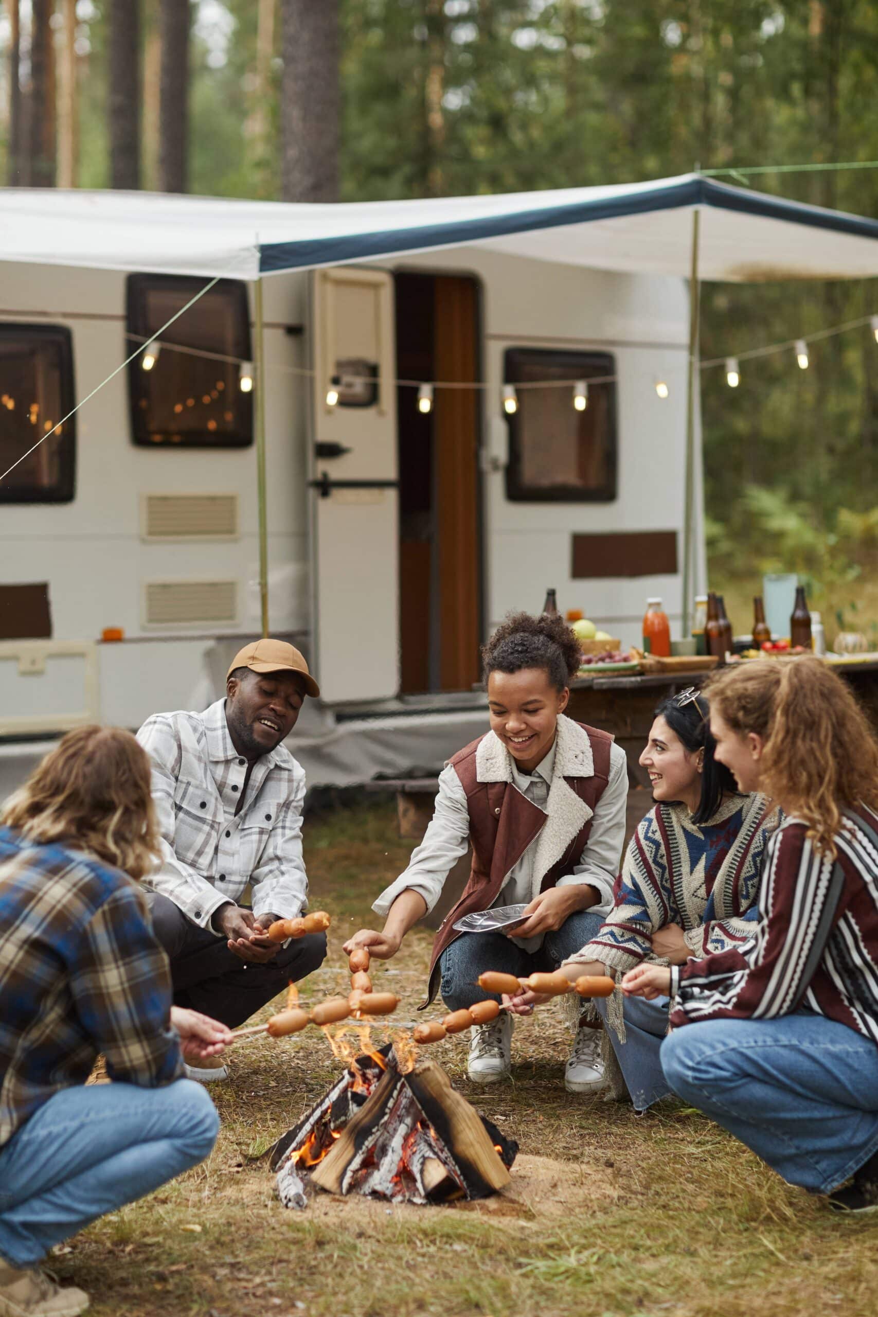Diverse group of friends by bonfire scaled
