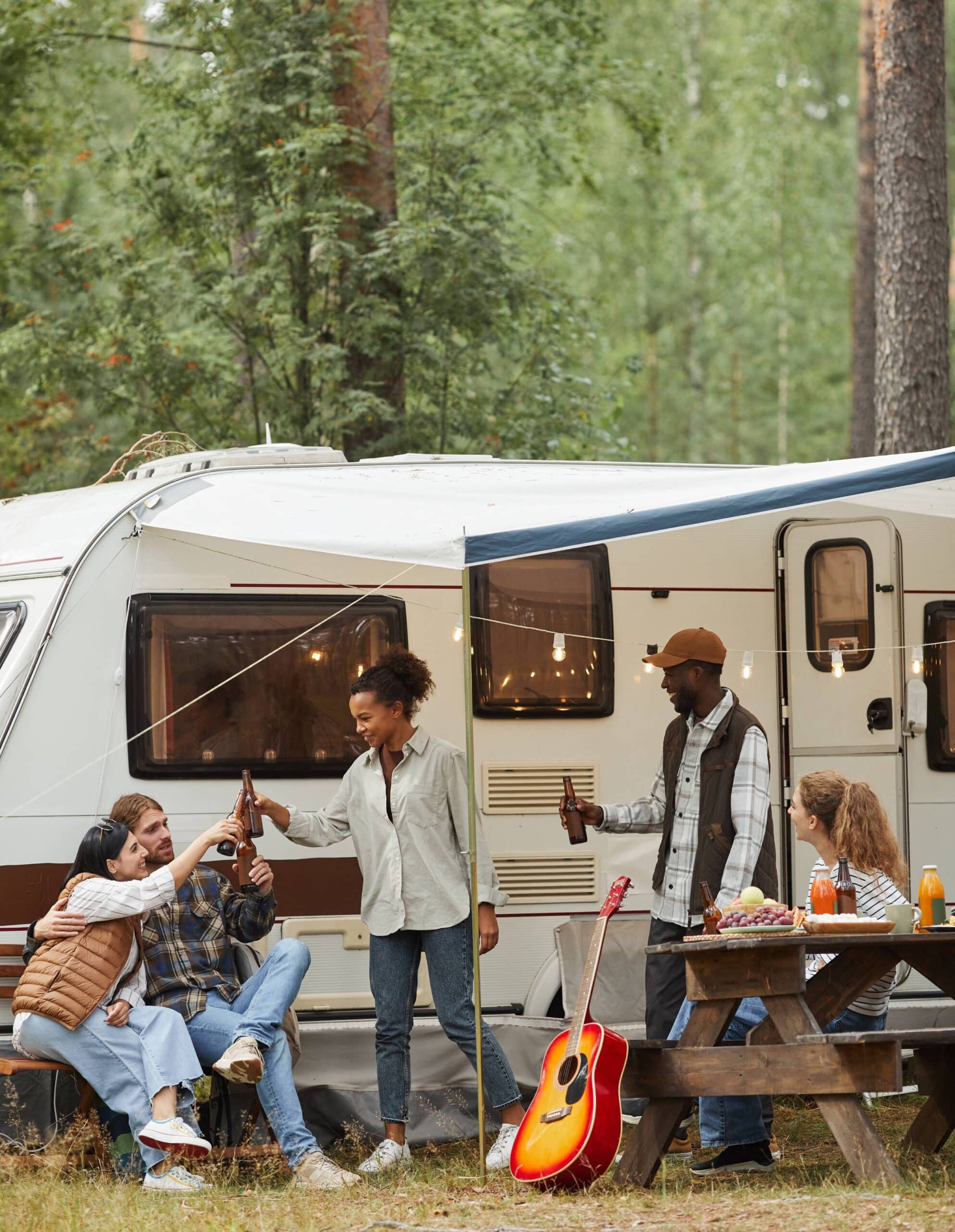 Friends relaxing by rv van outdoors scaled